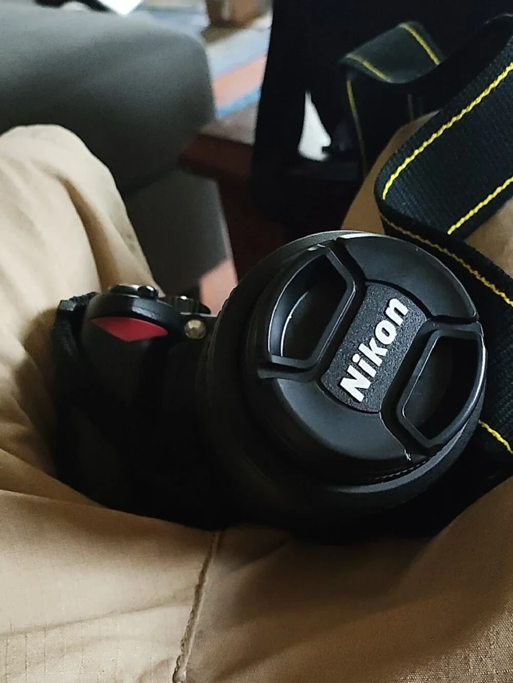 Nikon Black DSLR with Telephoto Lens and Branded Strap
